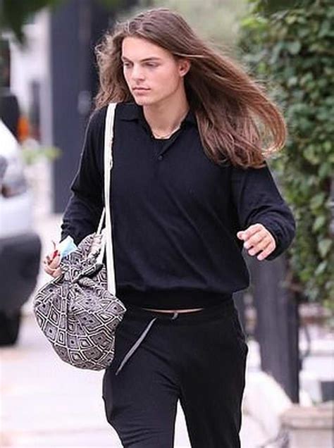 a woman walking down the street carrying a purse