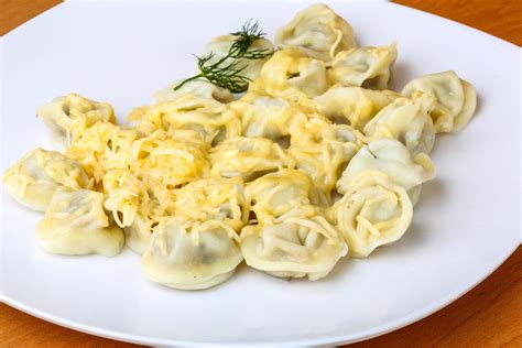 Russian dumplings on the plate and wooden background 12728232 Stock ...