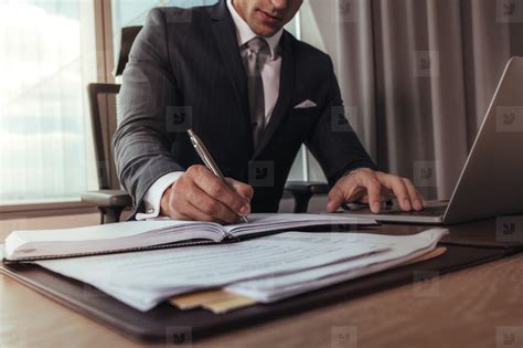 Businessman working at his office desk Photo (136638) - YouWorkForThem