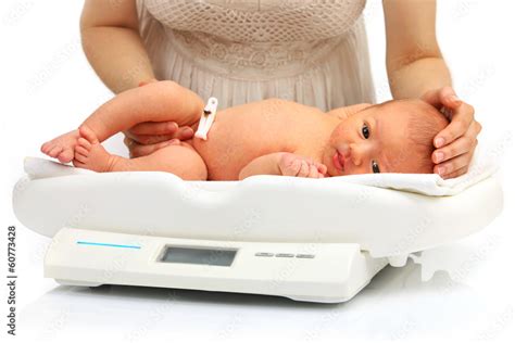 Newborn baby on a weight scale Stock Photo | Adobe Stock