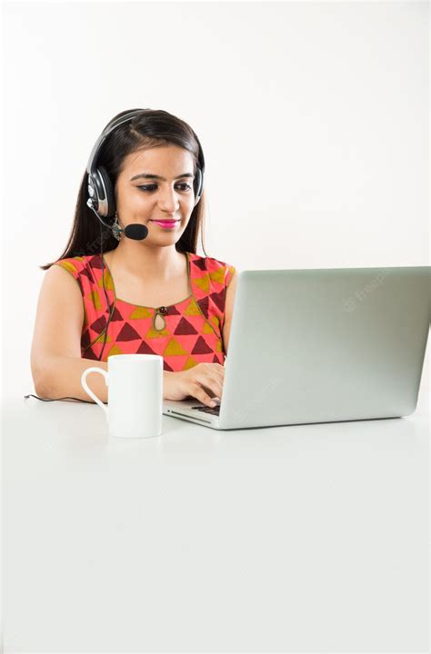 Premium Photo | Pretty Indian Asian Girl or BPO or Call Centre employee speaking on headphone ...