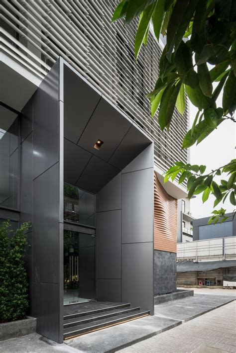 the entrance to an office building with glass doors and stairs leading up to it's second floor