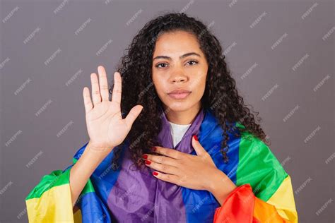 Premium Photo | Young brazilian black woman stop sign with hand militancy with lgbt flag ...