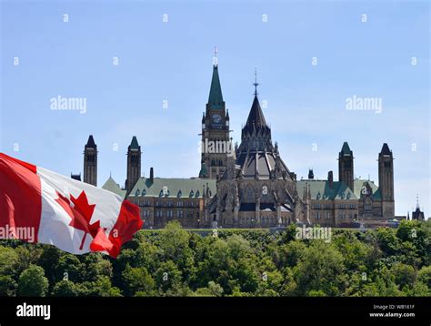 View of Canadian Parliament Hill from back side with Canada flag on left Stock Photo - Alamy