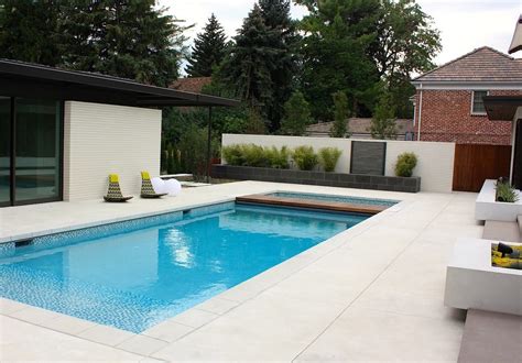 This stunning Sandscape Refined concrete pool deck by Bomanite offers the homeowners a hardscape ...
