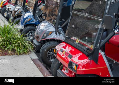 The Villages Florida retirement community with golf carts lined up in park Stock Photo - Alamy