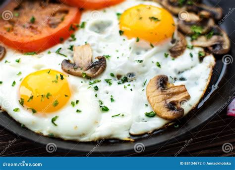 Fried Eggs with Mushrooms and Tomato on Dark Wooden Table Stock Photo ...