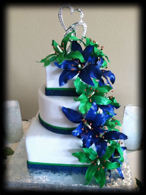 Wedding cake with green and blue sugar lilies | Emerald green weddings, Green wedding cake ...