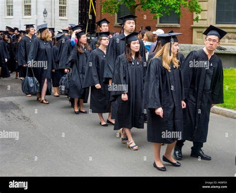 Wearing graduation caps and gowns, multiracial Harvard University ...