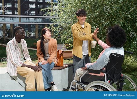 Young People Greeting Their Friend with Disability Outdoors Stock Image ...