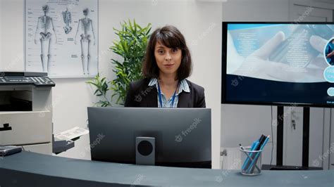 Premium Photo | Portrait of receptionist working at hospital reception ...