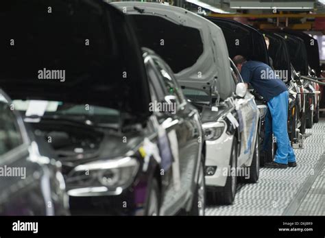 A BMW employee works on a BMW inside the company's plant in Dingolfing ...