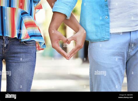 Couple making heart shape with hands Stock Photo - Alamy