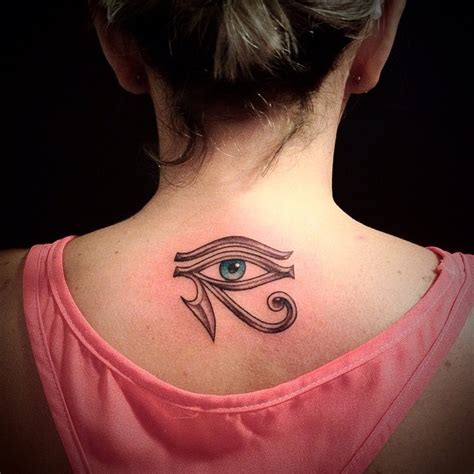 Mystical ancient Egyptian symbol the Eye of Horus tattoo on lady"s upper back - Tattooimages.biz