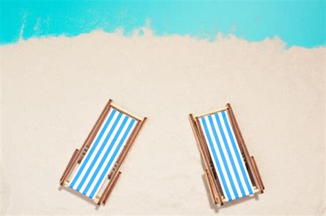 Premium Photo | Top view of two wooden beach chairs in row on beach.