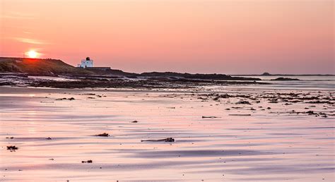 Bamburgh beach and lighthouse at sunset | This part of Bambu… | Flickr