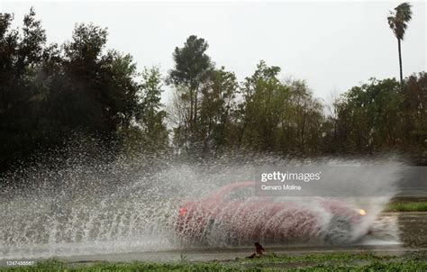 ENCINO, CA - FEBRUARY 24, 2023 - A car is framed by water at a... News ...