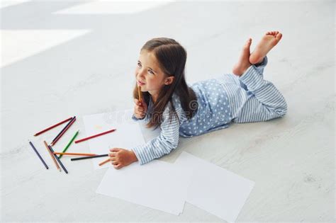 Lying on the Floor and Drawing. Cute Little Girl Indoors at Home Alone Stock Photo - Image of ...