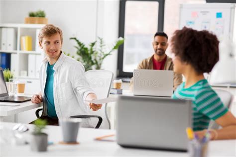 Happy Creative Workers with Laptops at Office Stock Photo - Image of giving, coworker: 114299252