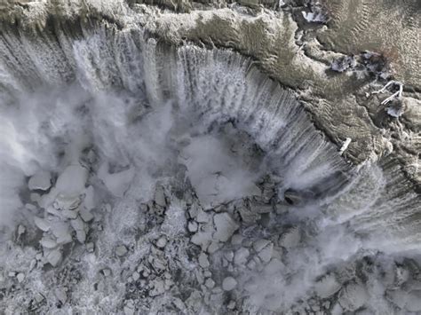 Spectacular photos show Niagara Falls partially frozen after winter storm