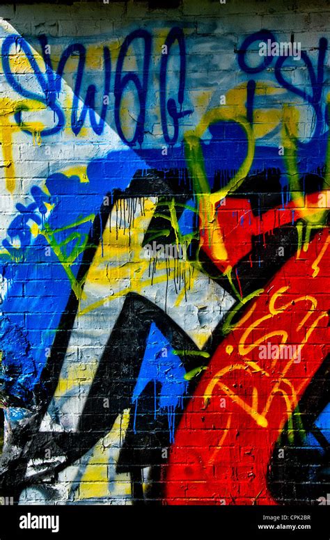 Colorful graffiti on a white brick wall Stock Photo - Alamy