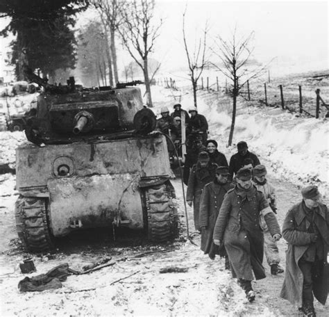 German POWs marching past a knocked-out M4A3E2 "Jumbo" in Foy, Belgium ...