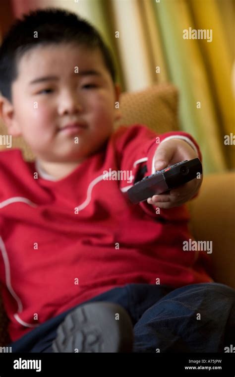 Young boy using remote control Stock Photo - Alamy