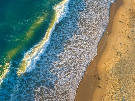 drone view of ocean waves crashing on the sand beach at roker beach, summer sunrise waves 4k HD ...