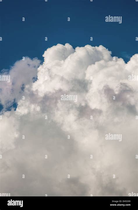 Storm clouds rolling past clear skies Stock Photo - Alamy