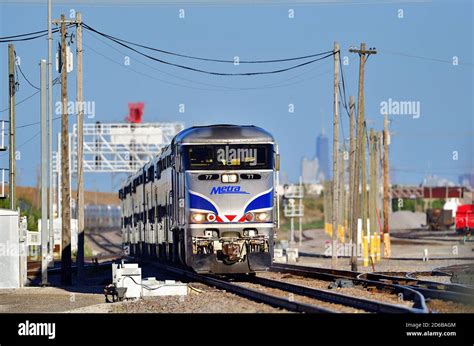 Bensenville, Illinois, USA. A Metra commuter train passing under a signal tower just prior to ...