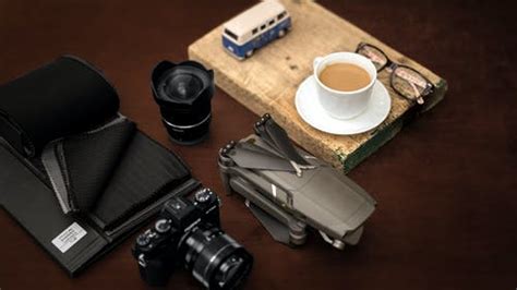 Modern photo camera on black surface · Free Stock Photo