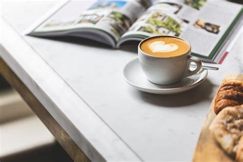 white ceramic coffee cup with saucer on white table - Cred… | Flickr