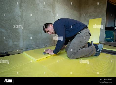 Installation of expanded polystyrene in the room for floor insulation ...