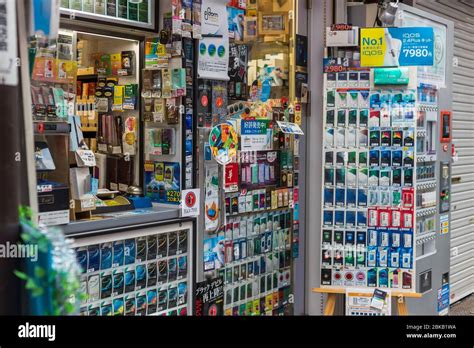 Cigarette kiosk shop in Japan with a variety of colors of many brands of cigarettes for sale ...