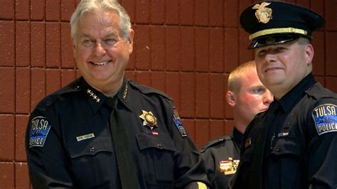 Chief Chuck Jordan congratulates new Tulsa police officer Kevin Kuebritz Oct. 28, 2016. (KTUL)