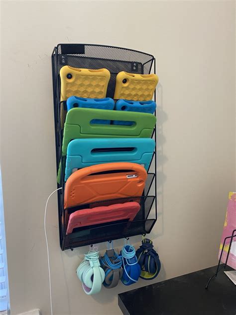 there is a black rack with many different cases on it and shoes next to ...