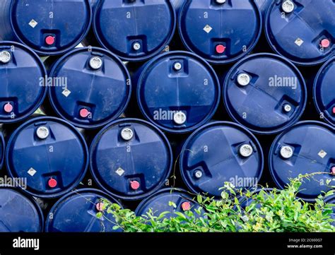 Closeup stack of chemical barrels. Blue oil drum. Plastic oil tank. Toxic waste warehouse ...