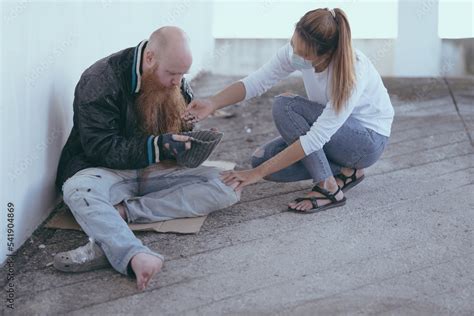 female giving money to poor or homeless people poverty beggar in the ...