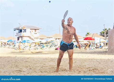 Adult Male Playing Matkot on the Beach Stock Photo - Image of ...