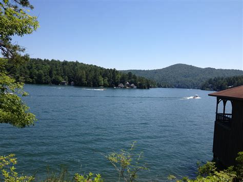 a boat is out on the water near some trees and a gazebo in the foreground