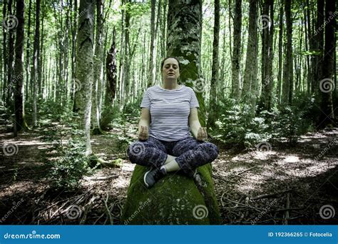 Woman meditating in forest stock image. Image of fitness - 192366265