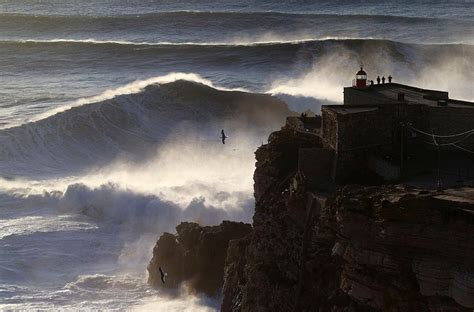 Photos: Massive waves tempt surfers off Portugal's coast | KOMO