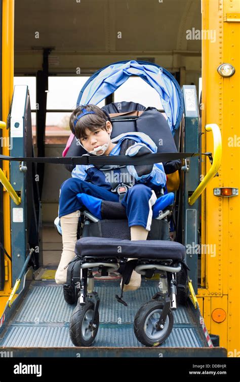 Disabled little boy on school bus wheelchair lift Stock Photo - Alamy