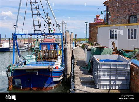 Fishing boat in the port of Burano, an island in the Venetian Lagoon, northern Italy. Burano is ...