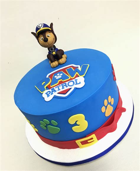 a blue birthday cake with paw patrol on top