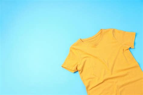 Premium Photo | Blank yellow t-shirt with space for print on blue ...