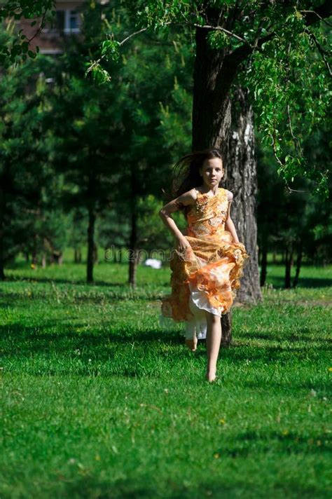 Girl in an Orange Dress is Spinning, Runs in the Summer in the Park Stock Image - Image of ...