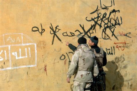 A U.S. Army soldier listens as an Iraqi interpreter explains the anti-American graffiti scrawled ...