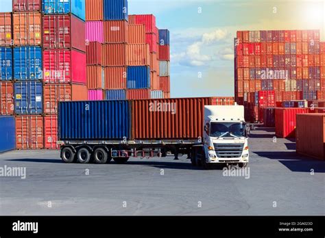 Container truck in cargo yard against blue sky transport background Stock Photo - Alamy