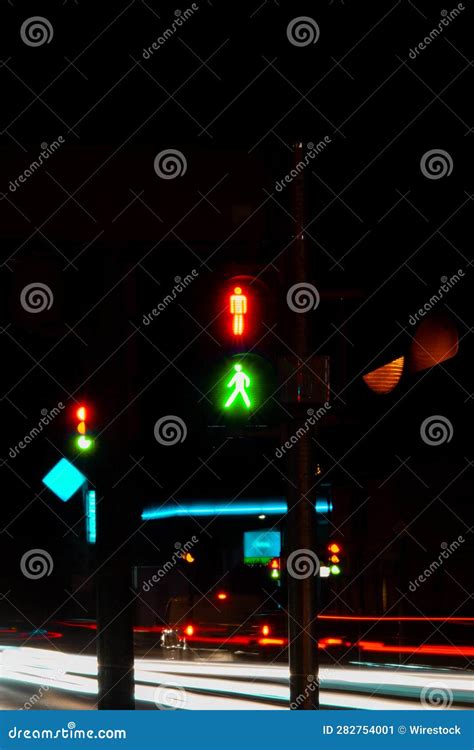 A Row of Cars Drive Past a Traffic Light with Green and Red Colors ...